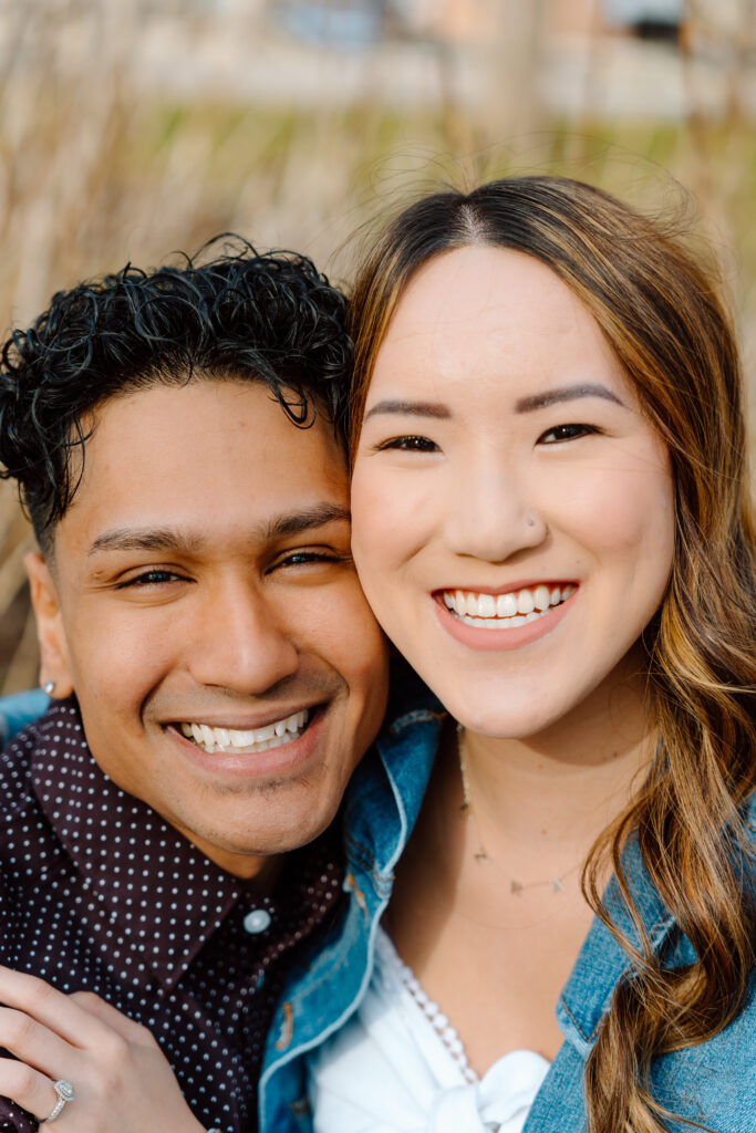 close up of engaged couple's faces smiling