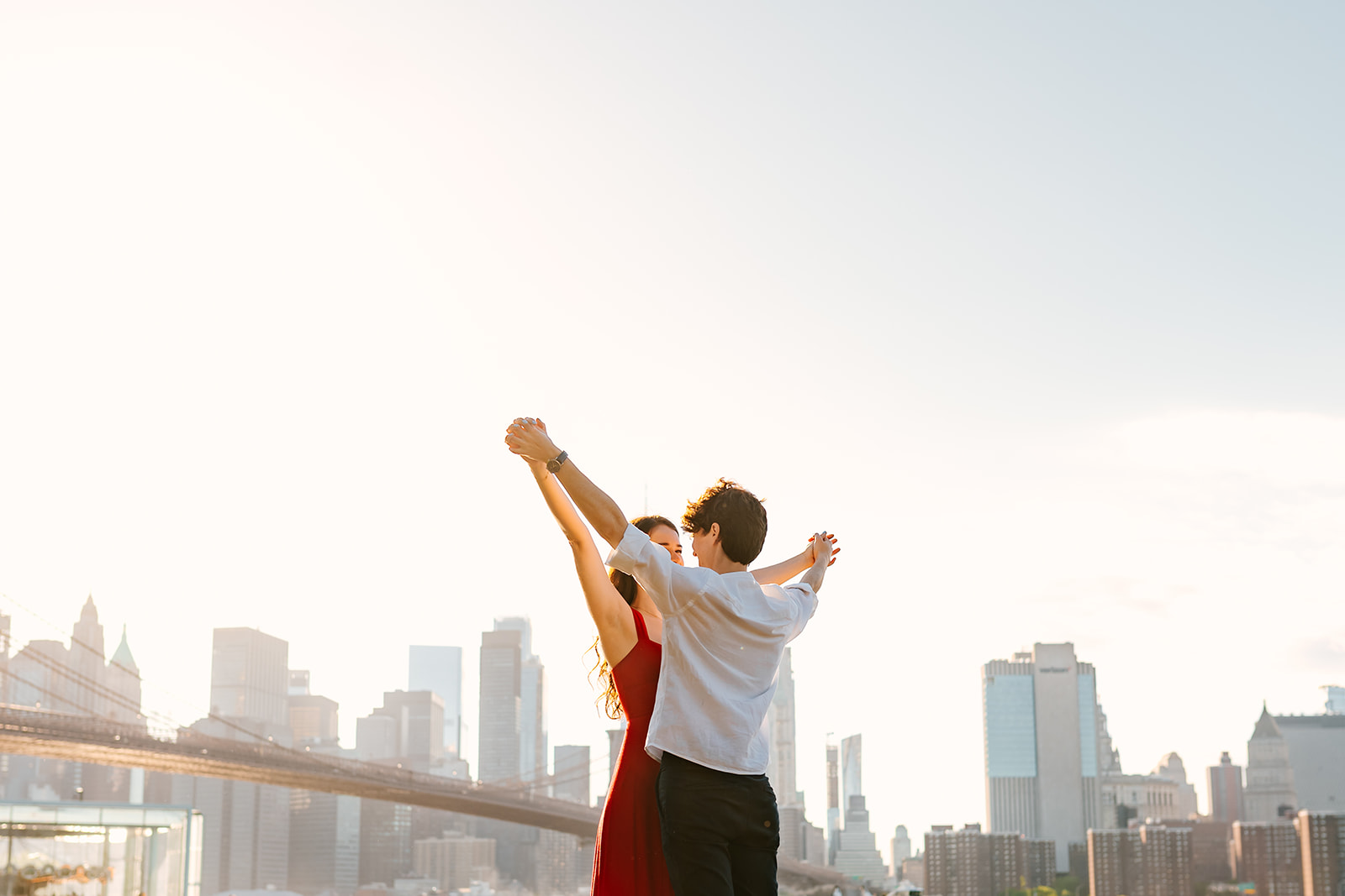 lgbtq couple holding hands with new york city skyline in the background