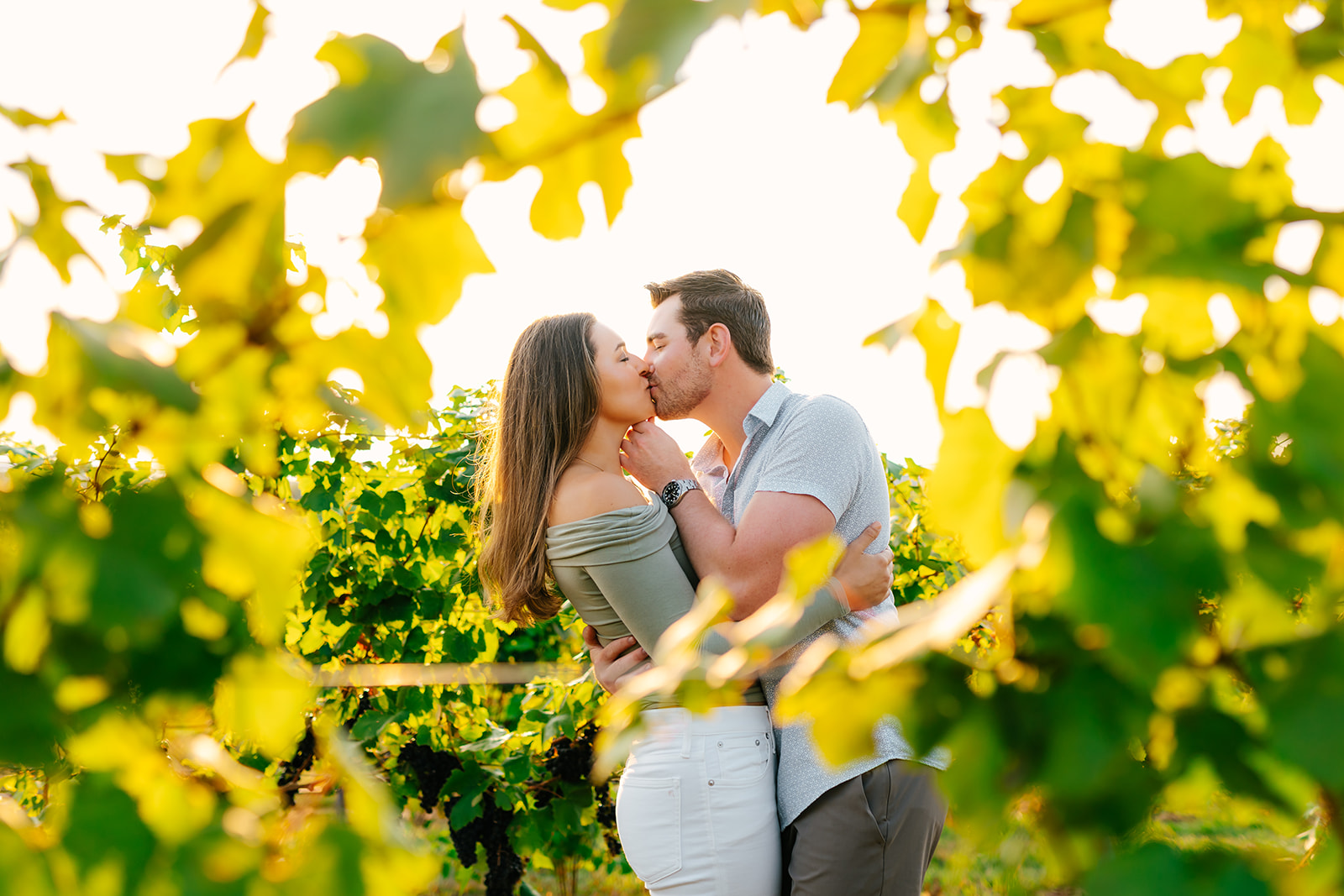 engaged couple kissing in chateau chantal in traverse city, michigan