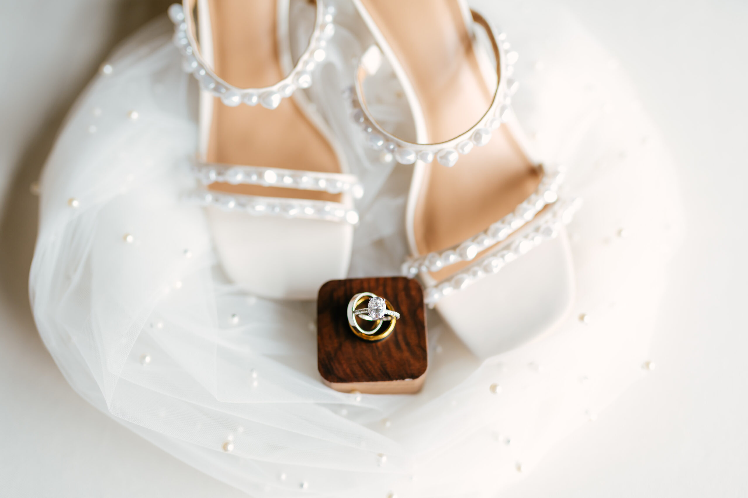 elegant wedding day details including veil, wedding rings, and shoes