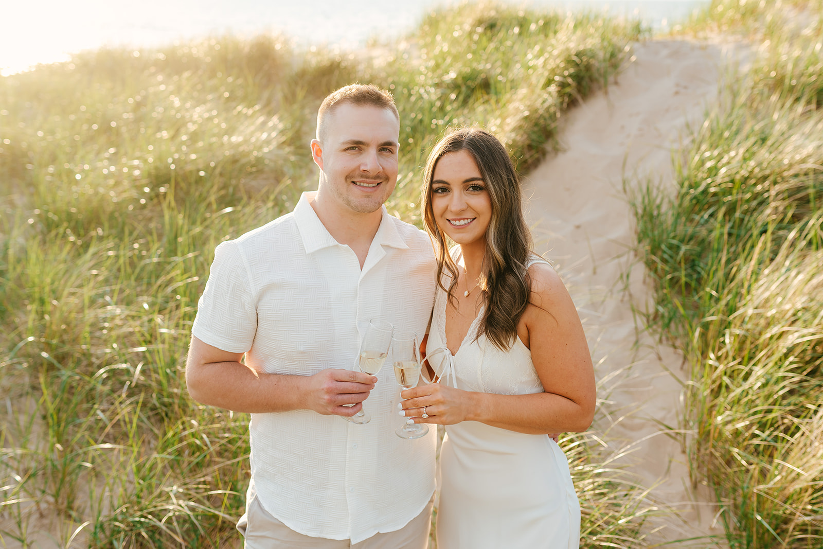 newly engaged couple celebrating with a photoshoot on lake michigan's shores