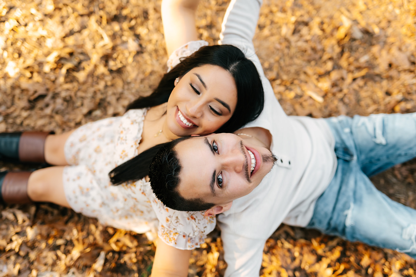 grand rapids michigan couple sitting on the ground in the woods
