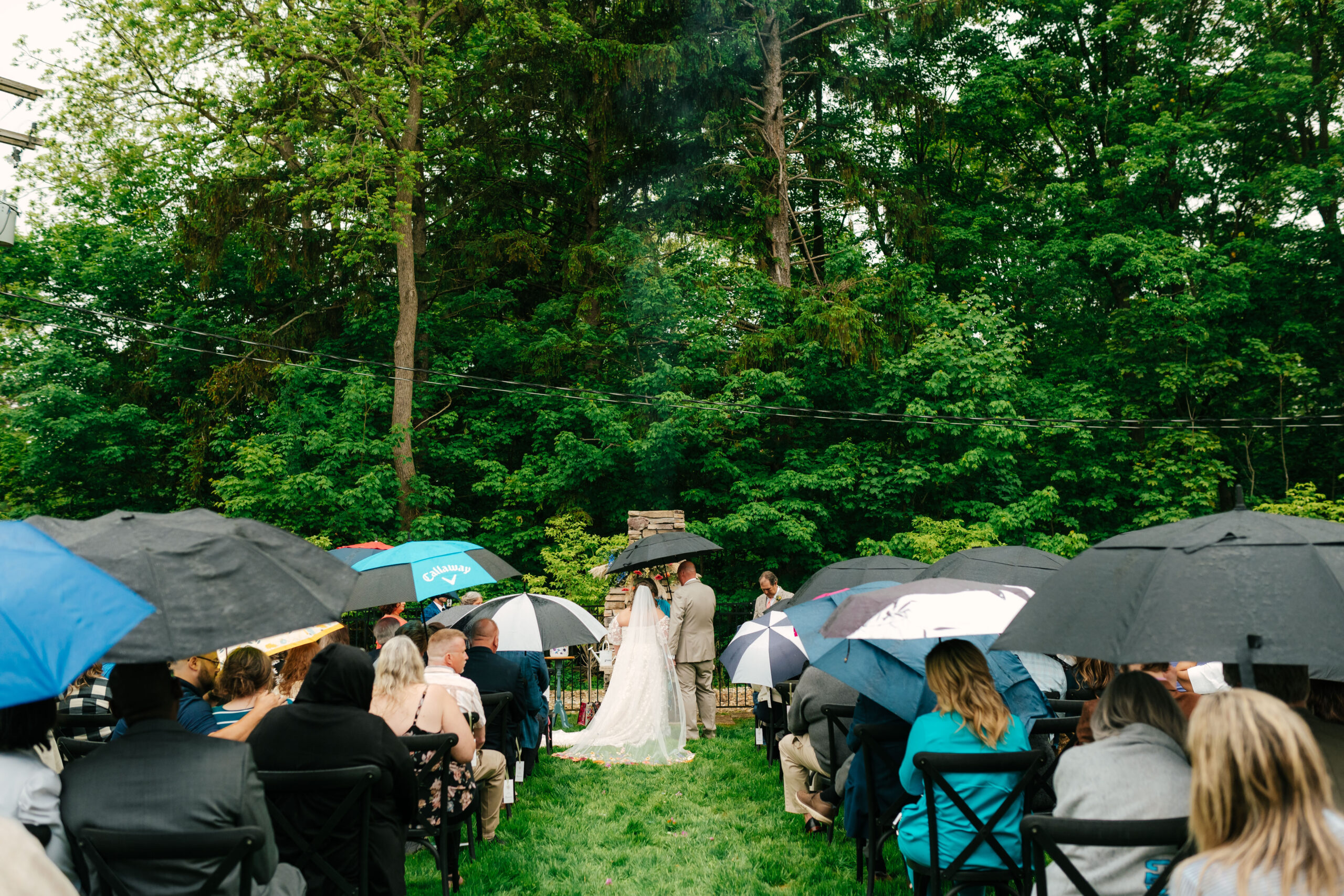 older couple embracing rain on their wedding day at south haven creations venue